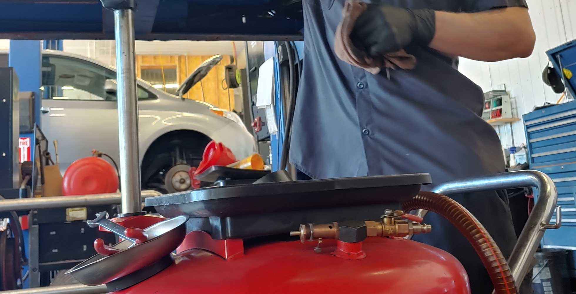 Paul's Auto Mechanic checks oil